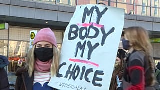 Protester holds up sign against Polish court ruling