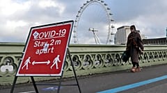 A woman walks over Westminster Bridge during the second coronavirus lockdown in London, Tuesday, Nov. 10, 2020