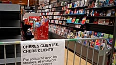 A barrier prevent customers to buy books in a supermarket of Saint Pee sur Nivelle, southwestern France, Tuesday, Nov.3, 2020. 