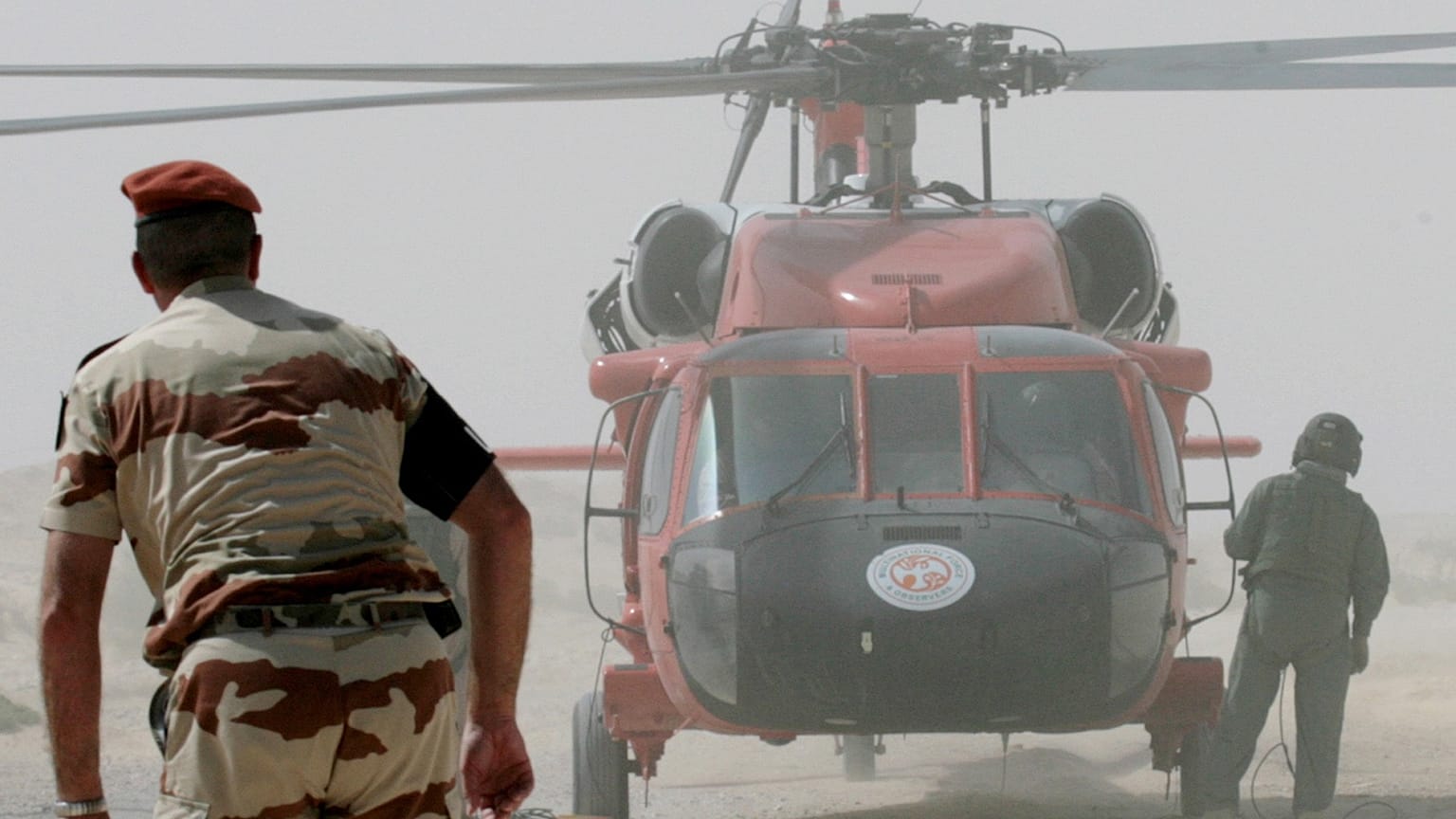 Multinational Force and Observers (MFO) helicopter and personnel work at the site of the French military transport aircraft crash in the Sinai region of Egypt in 2007 