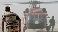 Multinational Force and Observers (MFO) helicopter and personnel work at the site of the French military transport aircraft crash in the Sinai region of Egypt in 2007 