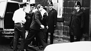 Peter William Sutcliffe (blanket on head) in Dewsbury in February 1981, where at the Magistrates Court he was committed in custody for trial on 13 counts of murder. 