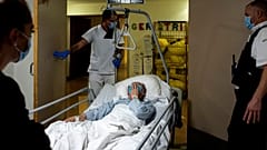 Medics from the Belgian military move a patient who is recovering from COVID-19 at the Andre Vesale hospital in Charleroi, Belgium on Friday, Nov. 13, 2020