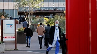 Dr Philippe Montravers arrives at the Bichat Hospital in Paris, Nov. 10, 2020. Montravers and the 150 doctors and nurses he leads have become experts on treating COVID-19.