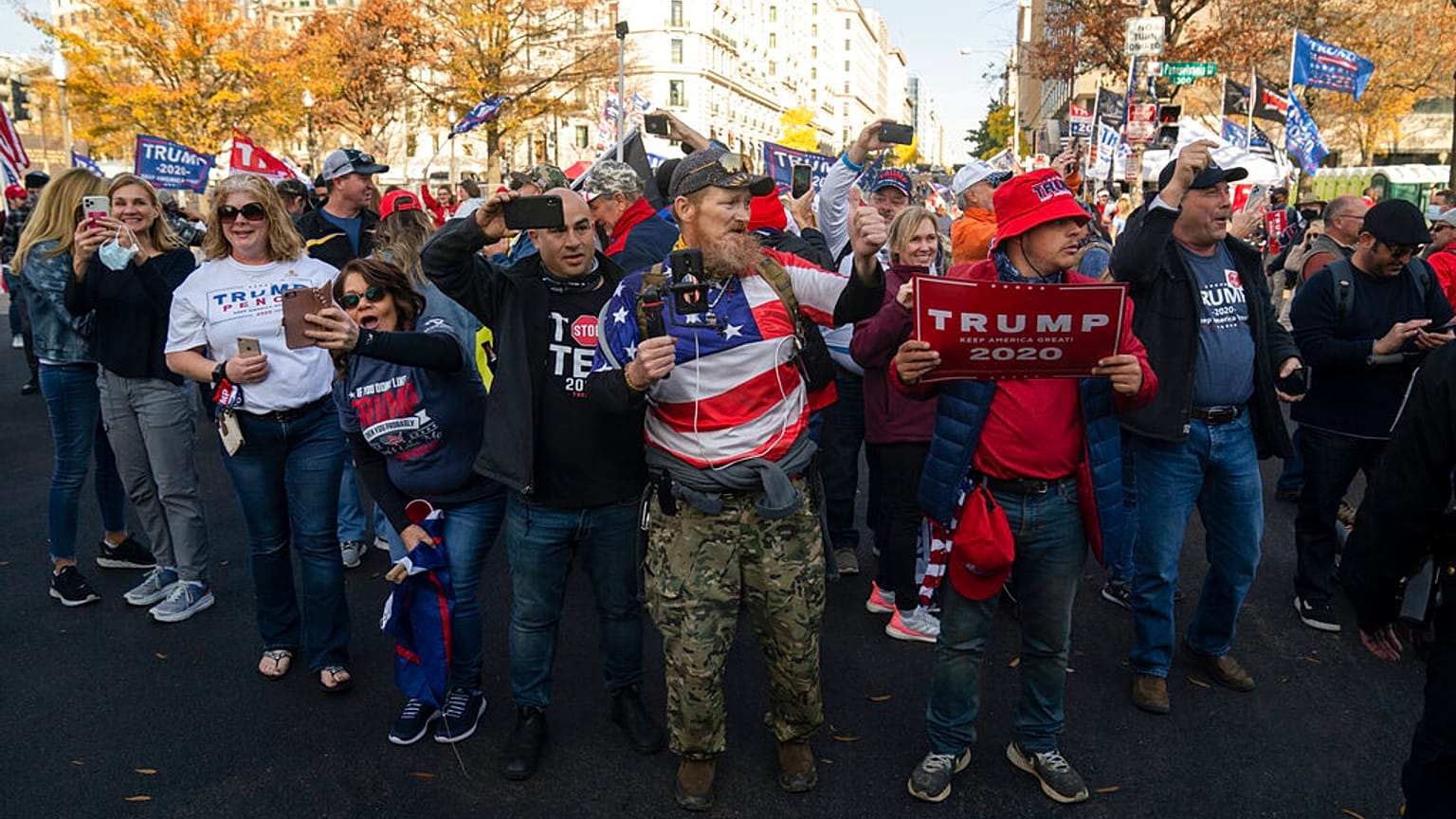 Supporters of President Donald Trump cheer as his motorcade drives past a rally of supporters near the White House, Saturday, Nov. 14, 2020, in Washington. (AP Photo/Evan Vucc