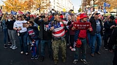 Supporters of President Donald Trump cheer as his motorcade drives past a rally of supporters near the White House, Saturday, Nov. 14, 2020, in Washington. (AP Photo/Evan Vucc