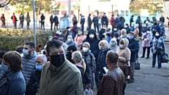 People wearing face masks queue at a polling station during the second round of Moldova's presidential election in the town of Varnita at Moldova - Transnistrian border