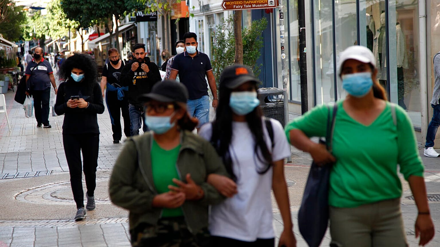 People wearing masks walk along Ledra street, a main shopping street in down town Nicosia