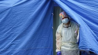 File photo: Medical works operate a testing tent at a COVID-19 mobile testing site in the Brooklyn borough of New York. Nov. 11, 2020.