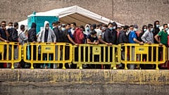 Migrants from a group of 1300 rescued from different boats remain in the port of Arguineguin while being cared for by the Spanish Red Cross
