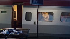 A police officer videos the crime scene inside a Thalys train at Arras train station, northern France, after a gunman opened fire with an automatic weapon.