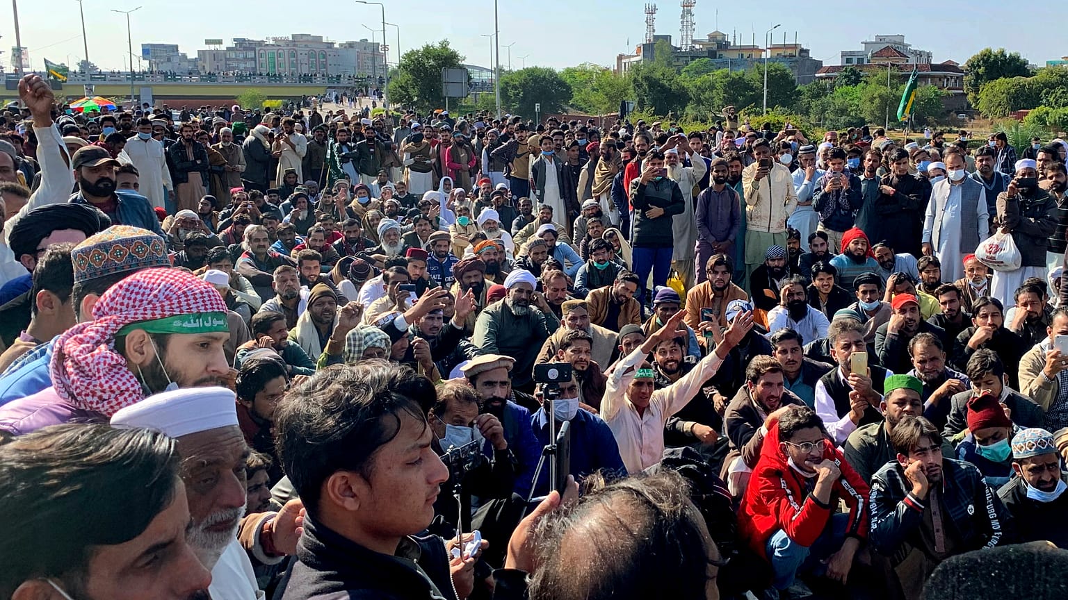 Supporters of Tehreek-e-Labaik Pakistan, a religious political party, block a main highway during an anti-France rally in Islamabad, Pakistan, Monday, Nov. 16, 2020.