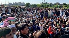 Supporters of Tehreek-e-Labaik Pakistan, a religious political party, block a main highway during an anti-France rally in Islamabad, Pakistan, Monday, Nov. 16, 2020.