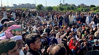 Supporters of Tehreek-e-Labaik Pakistan, a religious political party, block a main highway during an anti-France rally in Islamabad, Pakistan, Monday, Nov. 16, 2020.