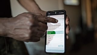 رجل يشير إلى مواعيد الصلاة على شاشة هاتفه المحمول في مارسيليا الفرنسية 