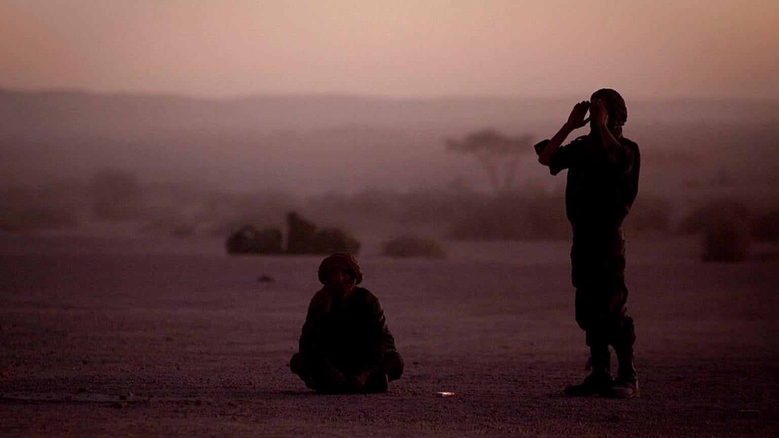 FILE - In this Feb.27, 2011 file photo, pro-independence Polisario Front rebel soldiers pray after sunset in the Western Sahara village of Tifariti.