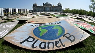 Activists place thousands of protest placards in front of the Reichstag building in Berlin on April 24, 2020.