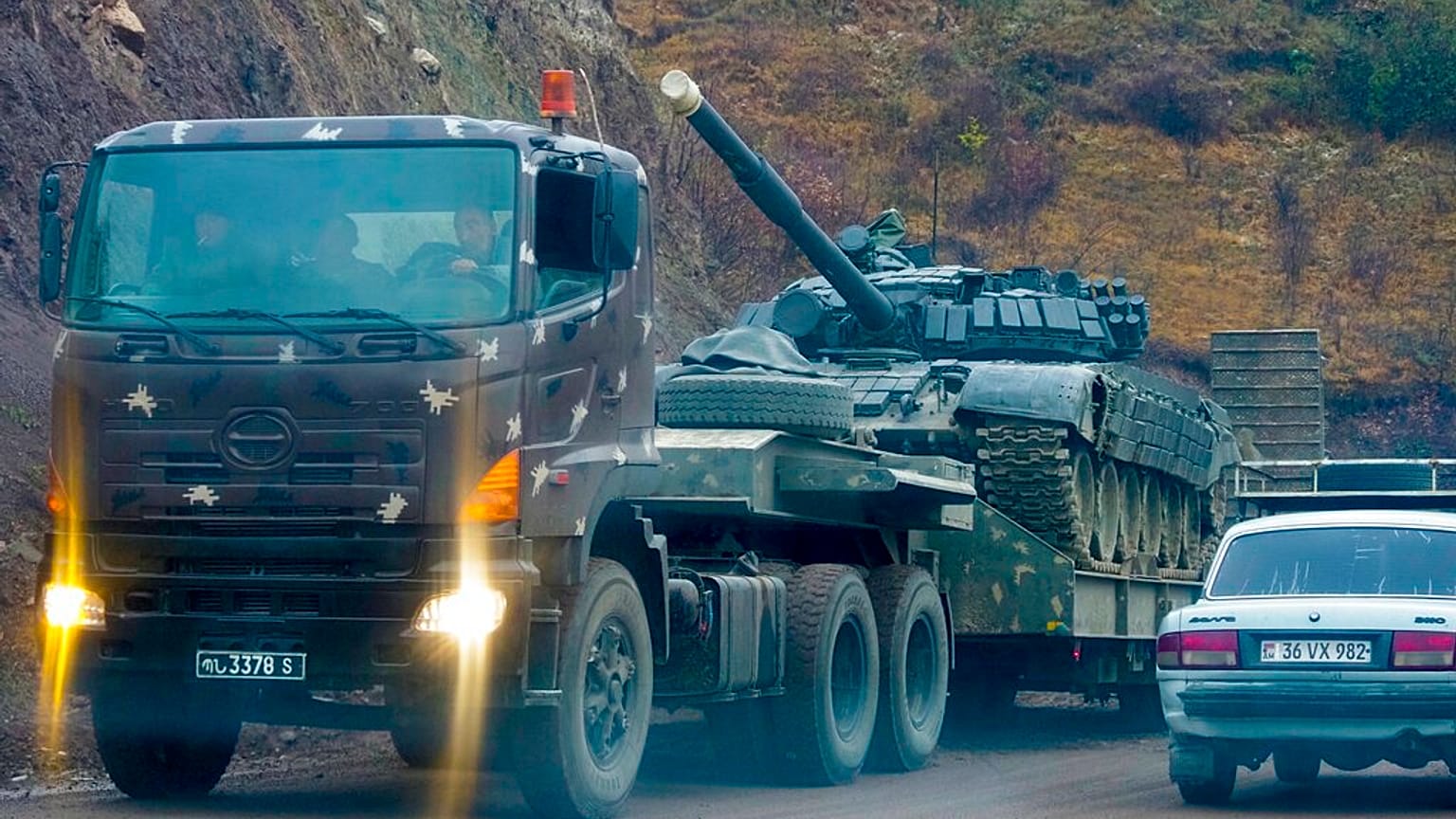 A truck carries an Armenian tank during the withdrawal of Armenian troops near the border between Nagorno-Karabakh and Armenia, Friday, Nov. 13, 2020.