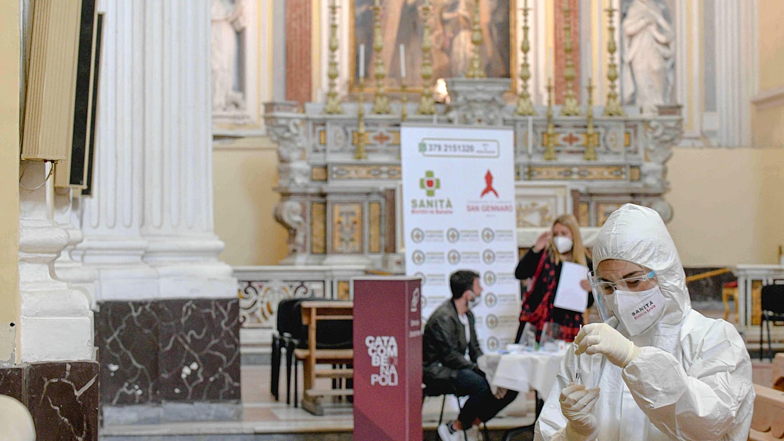 A medical operator prepares to perform COVID-19 test swabs in the Church of San Severo Outside the Walls, in the heart of Naples.