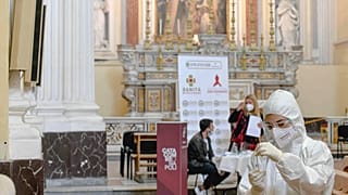 A medical operator prepares to perform COVID-19 test swabs in the Church of San Severo Outside the Walls, in the heart of Naples.