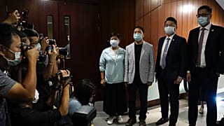 Pro-democracy legislators pose for photographers after handing their resignation letters at Legislative Council in Hong Kong on Nov. 12, 2020.