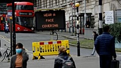 A sign is displayed outside London's Waterloo train station to remind people thy are required to wear face coverings inside the station 