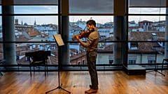 A musician in a face mask plays the violin at a rehearsal at the Teatro Real in Madrid, Spain, Friday, November 13, 2020.