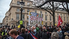 Demonstrators wearing masks stage a protest by the National Assembly against the security bill in Paris, Tuesday, November 17, 2020.