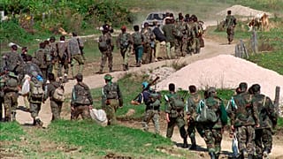 In this Sept. 28, 1995. file photo, a line of Bosnian government troops makes its way to the front-line near Mrkonjic Grad 120kms (80mls) north west of Sarajevo, Bosnia. 