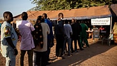 People line up to vote in Burkina Faso's presidential and legislative elections in Ouagadougou Sunday November 22, 2020.