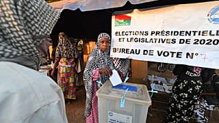 A voter casts her ballot at a polling station in Ouagadougou, during Burkina Faso's presidential and legislative elections.