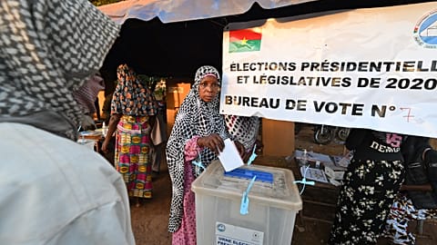 A voter casts her ballot at a polling station in Ouagadougou, during Burkina Faso's presidential and legislative elections.
