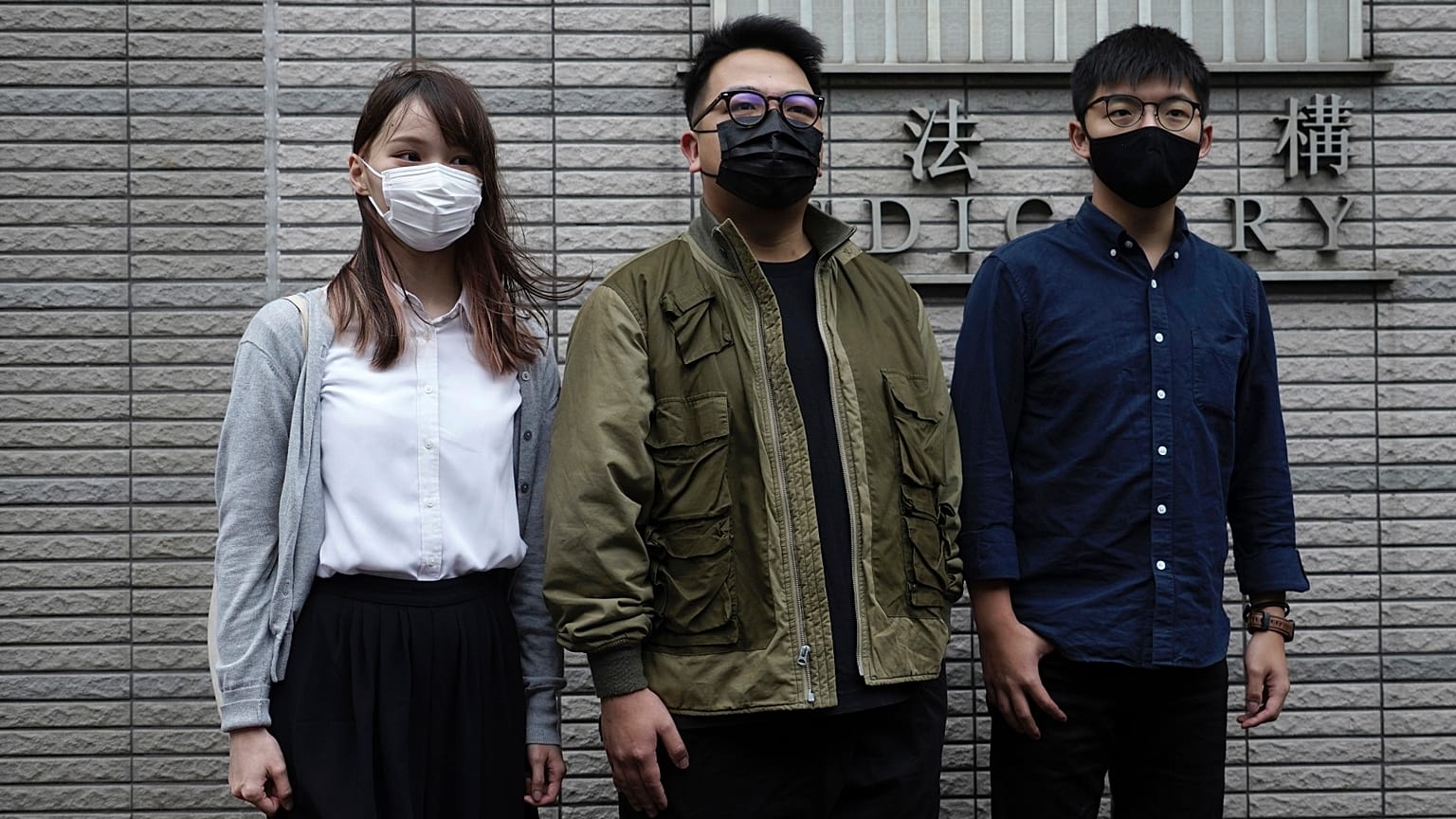 Hong Kong activists, from right, Joshua Wong, Ivan Lam and Agnes Chow at a court in Hong Kong, Monday, Nov. 22. 2020. 