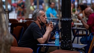 A man smokes on a terrace bar in Barcelona