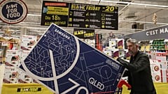 In this photo taken on Nov, 28, 2019, a customer walks in the Carrefour Shopping center on the eve of the Black Friday event, in Cesson, France.