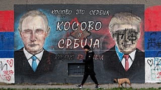 A mural depicting the Russian President Vladimir Putin, left, and US President Donald Trump in a suburb of Belgrade, Serbia. The graffiti reads "Kosovo is Serbia".