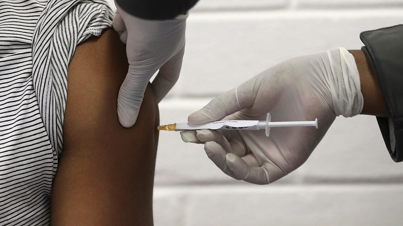 A volunteer receives an injection, as part of Africa's first participation in COVID-19 vaccine trials, June 24, 2020.