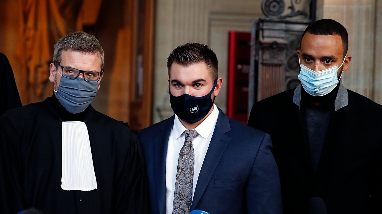 Alek Skarlatos, center, Anthony Sadler, right, and their lawyer Thibault de Montbrial at the Paris courthouse, Friday, Nov. 20, 2020.