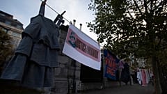Several people hung children's clothing outside the courthouse, alongside banners reading "Justice for Mawda".