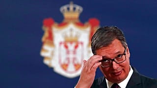Serbian President Aleksandar Vucic listens to European Commissioner for Neighbourhood and Enlargement Policy Oliver Varhelyi during a press conference in Belgrade, Serbia