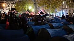 Police forcefully dismantle a refugee camp in central Paris.
