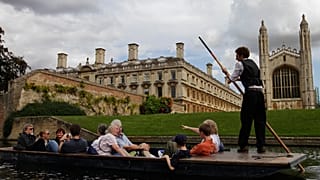Tourists enjoy a punt on the river Cam, in Cambridge, England. 