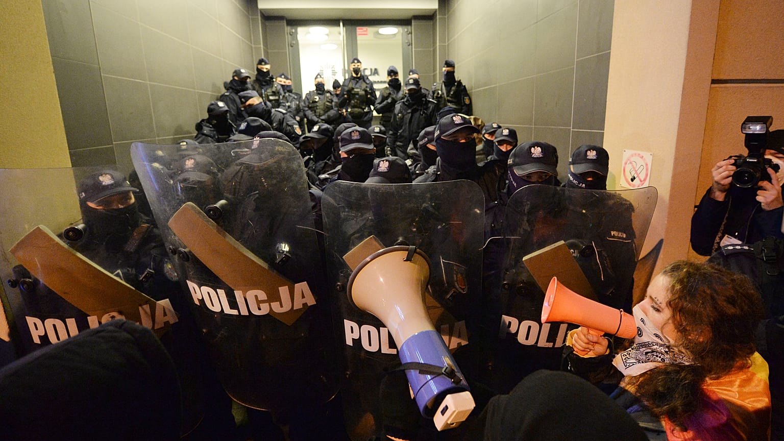 People block access to a police station where a few demonstrators are being detained after a pro-choice demonstration in Warsaw in Warsaw, Poland, Monday Nov. 23, 2020.