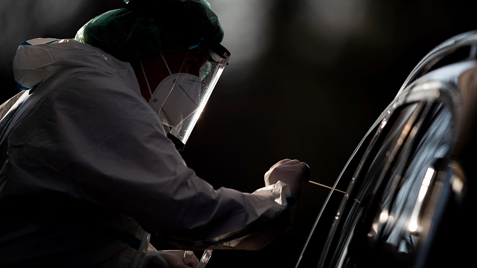 An employee takes a smear sample for a new coronavirus COVID-19 test  in Nuertingen, Germany, Wednesday, Nov 25, 2020. 