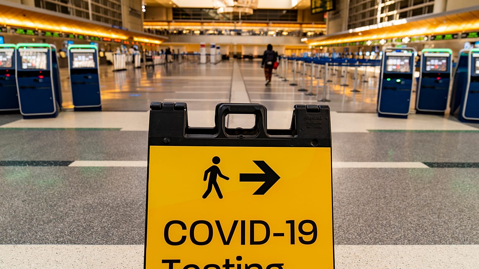A COVID-19 testing sign is posted at the empty Tom Bradley International Terminal at Los Angeles International Airport Wednesday, Nov. 25, 2020.