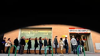 People line up to enter a government job center in Madrid,