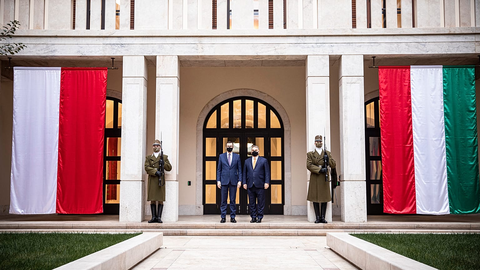 Hungarian Prime Minister Viktor Orban (2R) and Polish Prime Minister Mateusz Morawiecki posing during their meeting in Budapest, November 26, 2020.