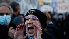 A protester shouts during a demonstration security law that would restrict sharing images of police, Saturday, Nov. 28, 2020 in Paris.