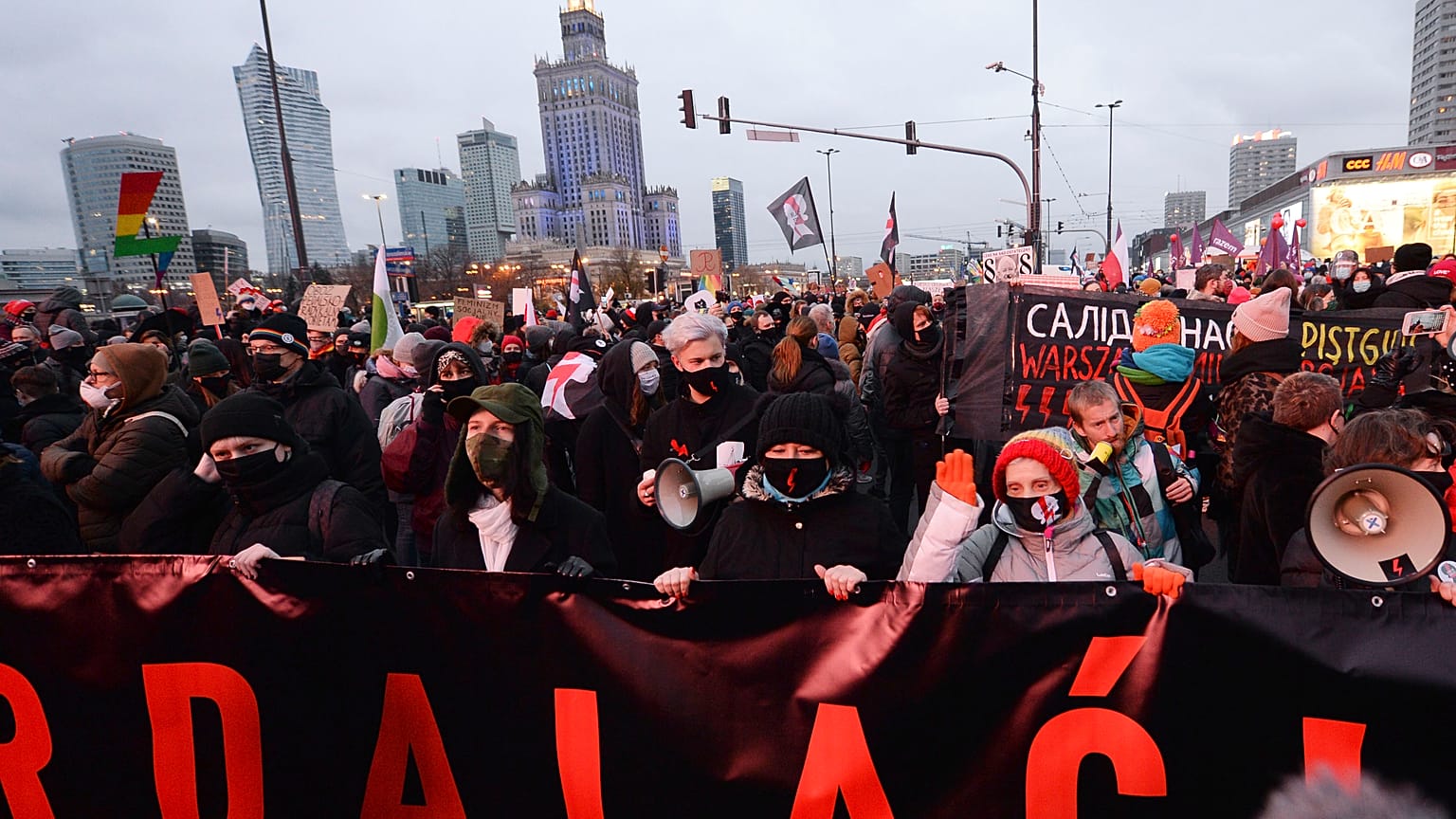 People demonstrate against police violence and an attempted restriction on abortion rights in Warsaw Poland, Saturday, Nov. 28, 2020