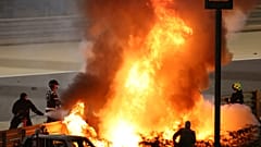 Staff extinguish French driver Romain Grosjean's car after a crash during the Formula One race in Bahrain, Nov 29, 2020.